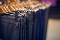 Showcase with men's trousers on hangers in a men's store. Royalty Free Stock Photo