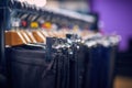 Showcase with men's trousers on hangers in a men's store. Royalty Free Stock Photo