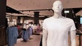 Showcase of a modern fashion store in a shopping center in the city center. One male mannequin in a white t-shirt with copy space Royalty Free Stock Photo