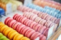 Showcase of rows of french macaroons. Close up of macaroon cookies