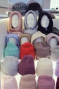 Showcase of trade tent with variety of women\'s hats knitted hats, scarves, hats