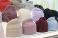 Showcase of trade tent with variety of women\'s hats knitted hats, scarves, hats