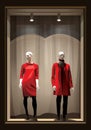 Showcase with two mannequins dressed in red and black clothes