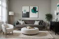 Abstract painting on grey wall o contemporary living room interior with emerald green armchair with round pillow, commode and couc Royalty Free Stock Photo