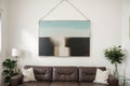 hanging a painting at home and decorating her contemporary living room