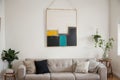 hanging a painting at home and decorating her contemporary living room