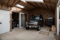 Home suburban countryside modern car and ATV double garage interior with wooden shelf, tools and equipment stuff storage warehouse