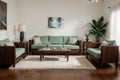 Kerala Indian Stylish interior design of living room with modern mint sofa, wooden console, cube, coffee table, lamp, plant, mock Royalty Free Stock Photo