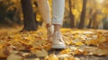Showcasing a Woman\'s Stylish Legs and Trendy Shoes on a Scenic Autumn Park Promenade