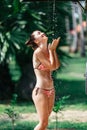 Shower On Beach. Beautiful Fit Woman Taking Shower At Swimming Pool. Girl With Body In Swimsuit Showering Under Royalty Free Stock Photo