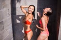 Shower On Beach. Two Beautiful Fit Woman Taking Shower At Swimming Pool. Girls With Body In Swimsuit Showering Royalty Free Stock Photo