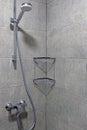 Shower cubicle with gray tiles.