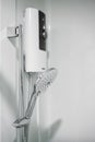 Shower and electric water heater in the bathroom. Royalty Free Stock Photo