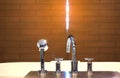 Shower faucet and head on bath tub with blur lit of door in bath room atmosphere with sun light Royalty Free Stock Photo