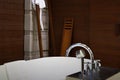 Shower faucet and head on bath tub with blur towel in bath room atmosphere Royalty Free Stock Photo