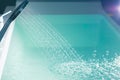 Shower filling a bathtub with water stream Royalty Free Stock Photo