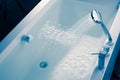 Shower filling a bathtub with water stream Royalty Free Stock Photo