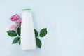 Shower gel bottle on light concrete background with pink flowers Royalty Free Stock Photo