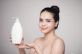 Shower gel. Joyful young woman advertising care product. Royalty Free Stock Photo