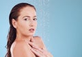 Shower, portrait and skincare with cleaning and woman in studio or blue background for wellness. Girl, cosmetics and