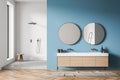 White and blue shower room with trendy mirrors