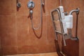 Shower with seat and grab bars for disabled and elderly people in the bathroom.