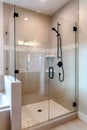 Shower stall with half glass enclosure and black shower head and handle