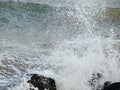 Shower of Water Droplets due to Sea Waves Crashing on Rocks Royalty Free Stock Photo
