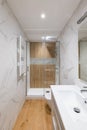 Shower zone with wooden finishing and glass door. Interior of modern refurbished bathroom Royalty Free Stock Photo