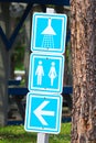 A showers and washroom directions sign at a campground