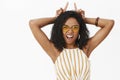 Showing all sides of temper. Portrait of daring energized and confident funny young african american woman in sunglasses