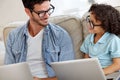 Showing Dad how its done. A little boy and his father working on laptops. Royalty Free Stock Photo