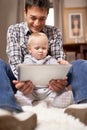 Showing dad how its done. A young father showing his baby girl how his digital tablet works. Royalty Free Stock Photo