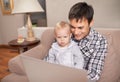 Showing dad how its done. A young father showing his baby girl how a laptop works. Royalty Free Stock Photo