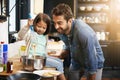 Showing dad a thing or two about cooking. a father and daughter making pancakes together. Royalty Free Stock Photo