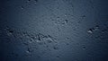 Dark Blue Textured Concrete Wall with Rough Surface and Cracks Illuminated by Dramatic Lighting Royalty Free Stock Photo