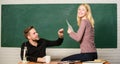 Showing a dedication to education. Man and woman back to school. High school education. Pretty teacher and handsome Royalty Free Stock Photo