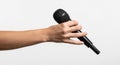 Hand holding a black microphone with a white background stock (1044 Royalty Free Stock Photo