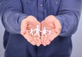 Showing, hands and man with paper family isolated on a purple background in a studio. Community, insurance and love for Royalty Free Stock Photo