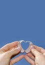 Showing a heart shape from hearing aids Royalty Free Stock Photo