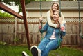 Showing her daughter unconditional love. a mother and her daughter playing on a swing in their backyard. Royalty Free Stock Photo