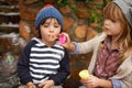 Showing him how its done. two cute kids blowing bubbles together outdoors. Royalty Free Stock Photo