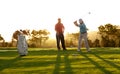 Showing him how its done. Two male golfers playing a round of golf. Royalty Free Stock Photo