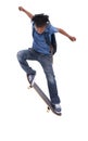 Showing off his mad skills. A young African-American boy doing a trick on his skateboard. Royalty Free Stock Photo