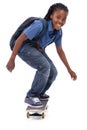 Showing off his mad skills. A young African-American boy doing a trick on his skateboard. Royalty Free Stock Photo