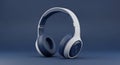 A pair of modern white and navy blue over-ear headphones is positioned centrally on a solid dark blue background Royalty Free Stock Photo