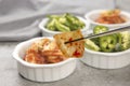 Showing a piece of kimchi in chopsticks Royalty Free Stock Photo
