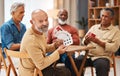 Showing, portrait and senior friends with cards for a game, playing and bonding in a house. Smile, show and elderly Royalty Free Stock Photo