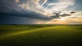 Rolling Green Hills Under a Dramatic Sky with Approaching Storm Clouds and Golden Sunset Rays Breaking Through Royalty Free Stock Photo