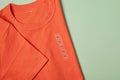 Showing size tag XL on orange t- shirt for selling in shop